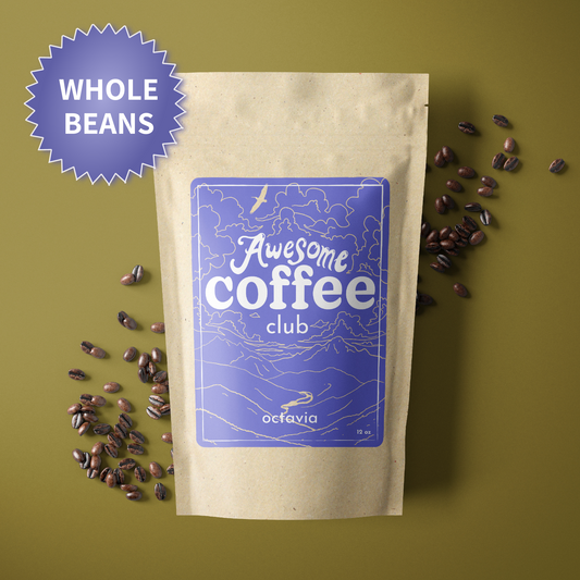 A photo of a brown bag of coffee with a light purple label that shows a mountain scene and has the text "Awesome Coffee Club; Octavia". The bag sites atop a dark yellow/green background with whole beans spread around it. There is a purple badge in the lefthand corner that reads "Whole Beans".